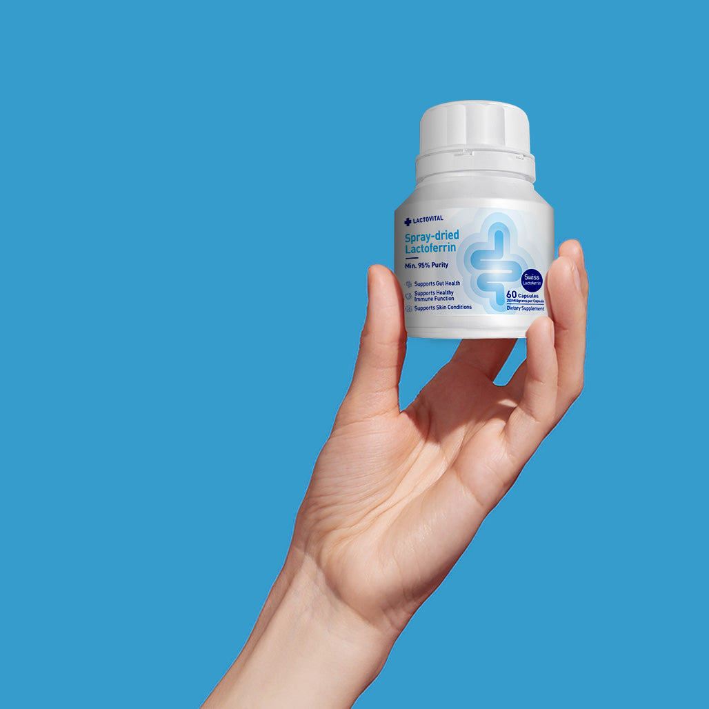 Lactovtial lactoferrin capsule pack shot with hand